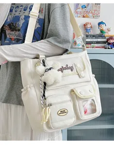 Japanese canvas shoulder bag sweet college messenger bag with cute plush pendant for commute.