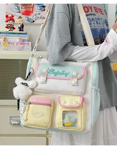 Detailed view of Japanese ins-style color-matching canvas messenger bag with cute plush pendant.