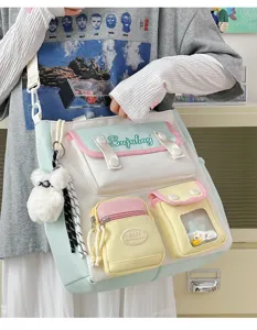 Japanese style aesthetic canvas messenger bag with multi pockets and cute plush bear charm for commute.