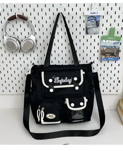 Japanese style canvas messenger bag, black shoulder bag with contrast trim and multiple pockets.