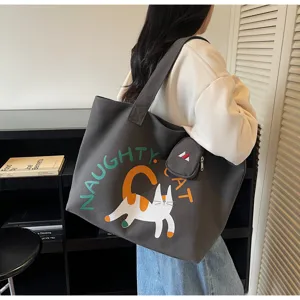 Casual large capacity canvas tote bag with cute cat graphic and shoulder strap for women.