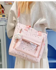 Japanischer süßer rosa Segeltuch-Umhängetasche mit Sternenmuster, transparenter Tasche und Anhänger.