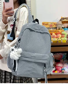 Black and white checkered backpack with cute plush bear pendant for daily casual student use.