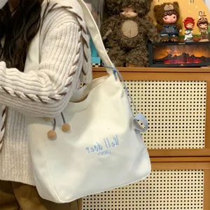 Lässige weiße Segeltuch Tote Bag für Damen, süße Umhängetasche mit blauer Stickerei.