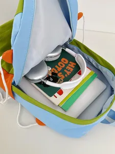 Cute color-block student backpack showcasing large capacity open interior with laptop and books.