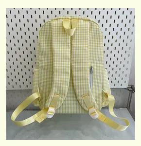 Yellow and white gingham school backpack detail, adjustable straps and back zipper pocket.