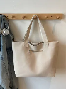 Large capacity canvas shoulder bag for women, casual tote with front zipper pocket.