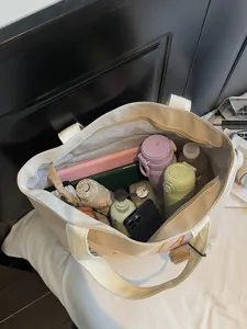 Large capacity canvas tote bag for women, casual commuter shoulder bag with interior pockets.