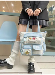 Joli sac ita bleu à pois avec une poche transparente et de jolies petites peluches.