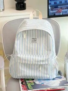 Detail view of a fresh Japanese style striped canvas backpack with front pocket and top handle.