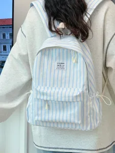Detail view of Japanese style striped canvas backpack showing front pocket, cute patch and straps.