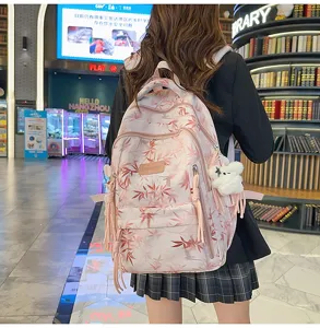 Chinese style bamboo leaf print student backpack with side tassels and cute bear pendant.