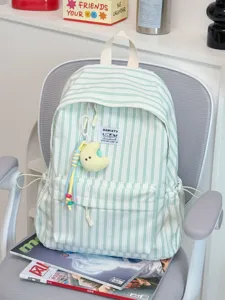 Green striped canvas backpack detail shot, featuring front pocket, zipper and cute pendant.