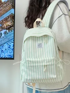 Detailed view of the fresh green and white striped canvas backpack with front pocket.