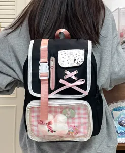 Detailed view of cute Japanese anime style ita backpack with clear front pocket and pins.