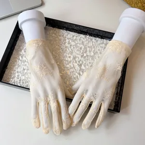 Detailed shot of women's short floral lace sun protection gloves, breathable mesh summer gloves.