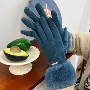 Detailed shot of dark green women's winter touch screen gloves with plush warm cuffs.