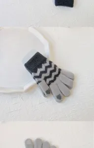 Detailed view of winter knitted touchscreen gloves with chic zigzag pattern design.