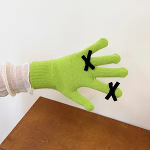 Green knitted touch screen gloves with black bow design for women winter daily wear.