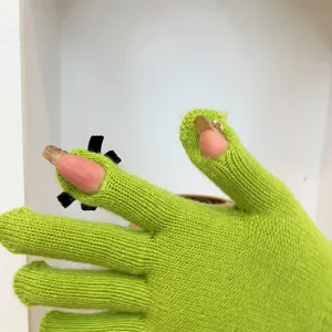 Green knit touchscreen gloves with cute black bows and exposed fingertips for winter wear.
