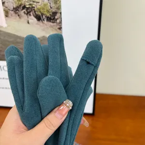 Detail view of winter thermal fleece touch-screen gloves in dark green, soft and warm fabric.