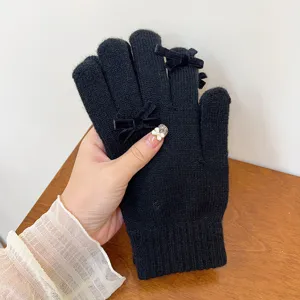 Women winter knit warm gloves detail display, solid black wool with sweet velvet bows.