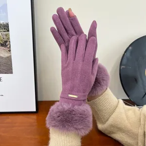 Close-up detail of winter women purple thermal gloves with soft fluffy faux fur cuffs.