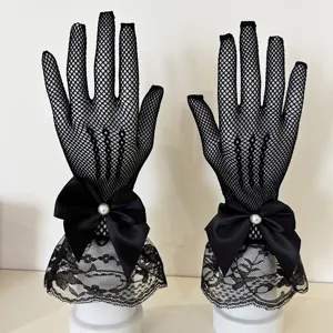 Detailed view of black fishnet lace gloves featuring elegant satin bow and pearl accent.