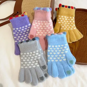 Detailed view of sweet knitted touchscreen gloves featuring cute heart patterns and soft warm wool.