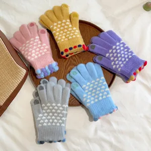 Women's cute knitted touchscreen gloves featuring cozy fleece lining and sweet heart patterns.