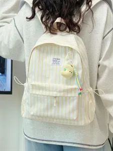 Detail shot of the striped canvas backpack featuring front pocket and cute pendant design.