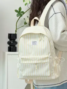 Detailed view of casual striped canvas backpack in fresh yellow and white color scheme.