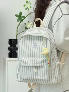 Japanese style striped backpack detail with cute plush charm pendant for daily casual look.