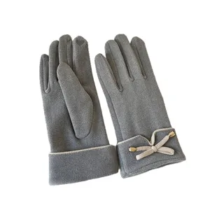 Detailed view of women's winter thermal velvet touch screen gloves with elegant bow and cuff.