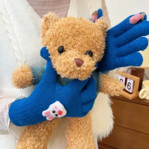 Detail view of blue knit fingerless gloves with cute bunny patch, soft winter warm wear.