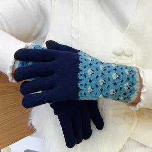 Close up view of winter knitted touchscreen gloves with blue pattern for warm daily wear.