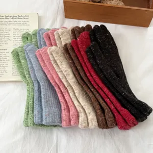 Knit gloves detail view showing soft woolen texture and multiple colorful winter choices.
