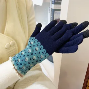 Close-up detail of women's knit winter touchscreen gloves in navy blue and light blue pattern.