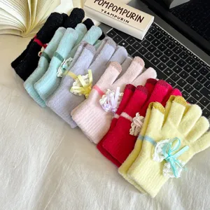 Detail view of women touch screen knitted gloves with cute lace bow, winter warm fuzzy gloves.