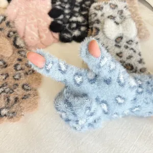 Detailed view of fluffy leopard print winter gloves, soft faux mink plush fingerless design.