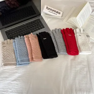 Close-up of stylish multi-color knitted hollow touch-screen gloves neatly displayed.