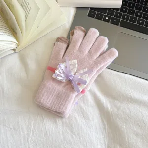 Pink knitted touchscreen gloves detail view featuring an elegant purple lace bow decoration for women.