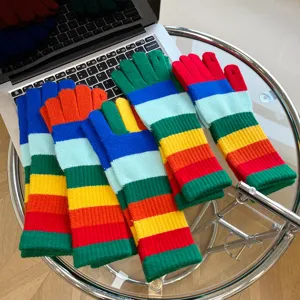 Colorful striped knitted gloves detail shot, warm winter accessory with multi-color design.