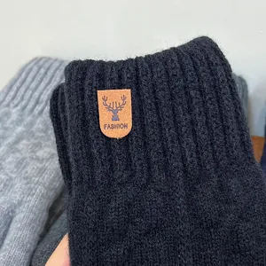 Men's winter warm knit gloves close up view, thick fleece lined touchscreen detail shot