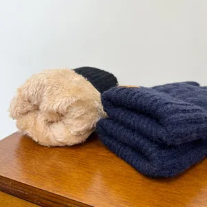 Detailed view of thick fleece-lined thermal knit gloves, showing soft interior plush fabric.