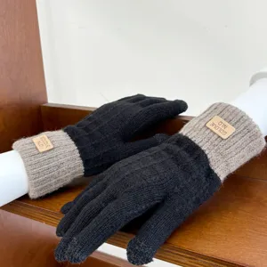 Detail view of women knit winter gloves featuring touchscreen fingertips and cozy cuffs.