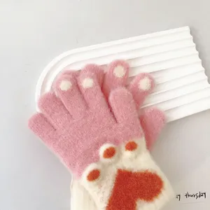 Detailed view of kids knit gloves featuring cute cat paw pads and heart jacquard pattern.