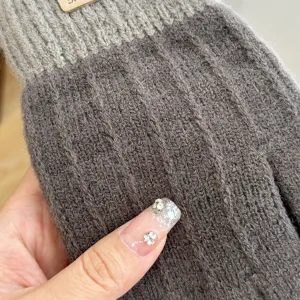 Close up view of women knitted wool warm gloves detail showing soft texture and cozy winter design.
