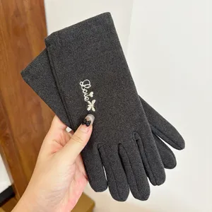 Dark grey thermal touch screen gloves detail view, showing delicate love embroidery and soft fabric.