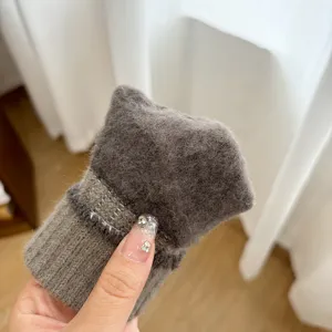 Close-up detail of soft winter knitted warm wool glove cuff texture in dark gray style.